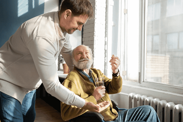 Caregiver assisting senior medication