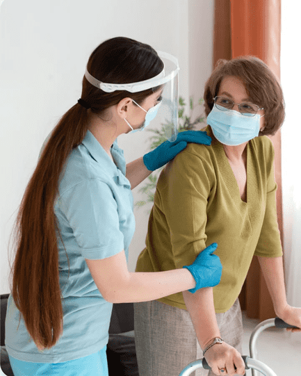 Caregiver supporting elderly woman with walker